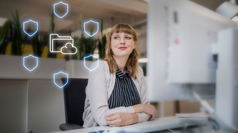 Woman at computer smiling with data security icons next to her