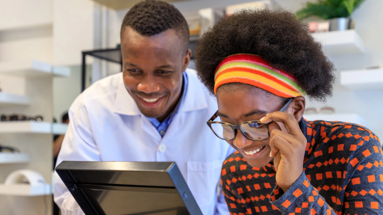 Provider with patient trying on glasses