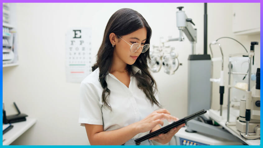 Provider scrolling through an iPad in an eye care office. 