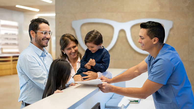 Family looking at materials with optometrist