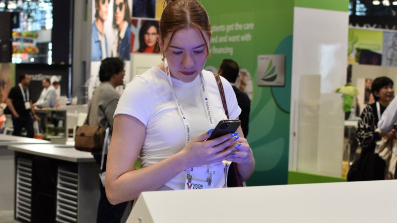 Woman looking at an interactive touchscreen in the VSP Vision VEE booth