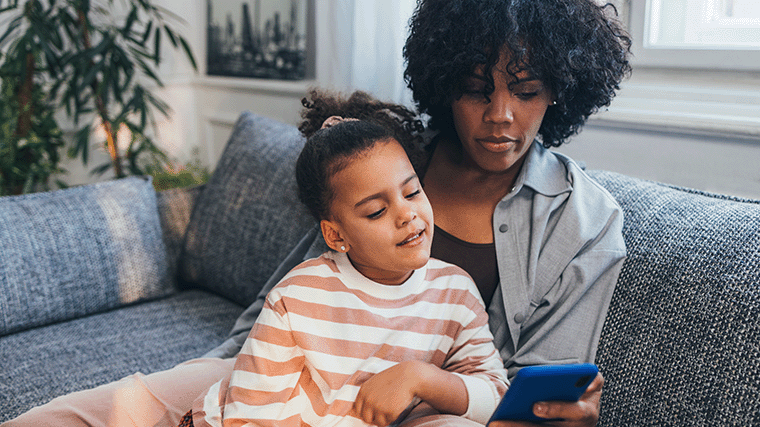 Mom and daughter booking an eye appointment online