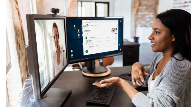 A tablet displays optometry software with a pair of glasses in the foreground.