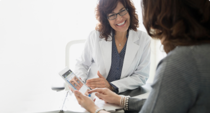 Provider showing a person a screen in Eyefinity EHR on a tablet