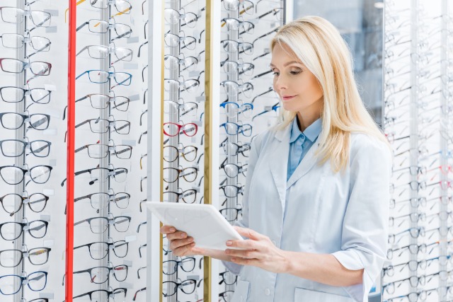 Woman looking at an iPad in front of a frame board