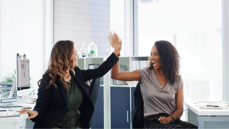 Staff members smiling and high-fiving