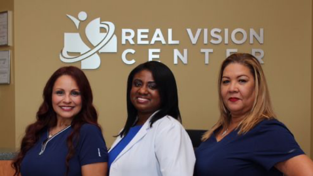 Three eye care professionals pose for a photo