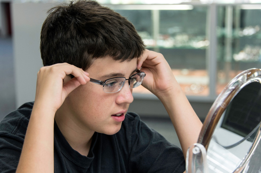boy tries on glasses 