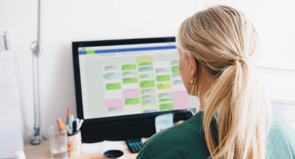 Woman looking at the appointment schedule on a desktop computer