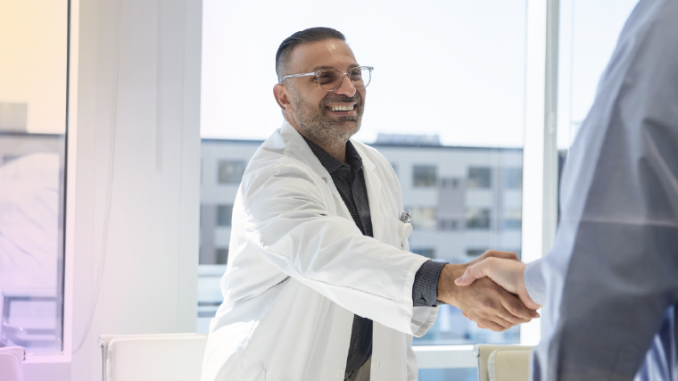 Provider smiling at patient holding an iPad
