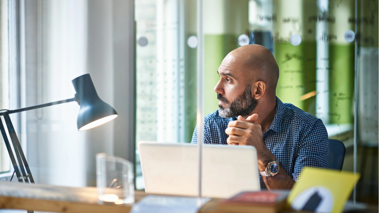 Person starring off into the distance in an office